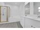 Modern bathroom featuring double vanity sinks, a soaking tub, and a glass-enclosed shower at 327 Cloverdale Rd, Winter Haven, FL 33884