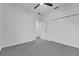 Neutral bedroom features a ceiling fan, double closet and gray carpet at 327 Cloverdale Rd, Winter Haven, FL 33884
