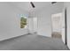 Bright bedroom with new gray carpet, closet, and window with natural light at 327 Cloverdale Rd, Winter Haven, FL 33884