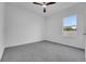 Spacious bedroom features a ceiling fan and a view of the outdoors through a window at 327 Cloverdale Rd, Winter Haven, FL 33884