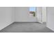 Bright and airy bedroom with a window providing natural light and soft gray carpet at 327 Cloverdale Rd, Winter Haven, FL 33884