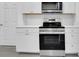The kitchen boasts stainless steel appliances and white cabinets, complementing the modern design at 327 Cloverdale Rd, Winter Haven, FL 33884