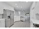 Bright kitchen with stainless steel appliances and white cabinets, open to dining area at 327 Cloverdale Rd, Winter Haven, FL 33884