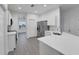 Modern kitchen with white cabinets, stainless steel appliances, a stylish sink, and a countertop with room for dining at 327 Cloverdale Rd, Winter Haven, FL 33884