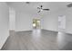 Open-concept living area with modern floors, a ceiling fan, and sliding doors that lead to an outdoor patio at 327 Cloverdale Rd, Winter Haven, FL 33884