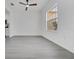 Bright living space featuring sleek floors, a ceiling fan, and a large window offering plenty of natural light at 327 Cloverdale Rd, Winter Haven, FL 33884