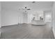 Spacious open-concept living area with sleek, grey flooring, white walls, and natural light flowing in from the exterior at 327 Cloverdale Rd, Winter Haven, FL 33884