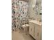 Cozy bathroom featuring a decorative shower curtain and accessibility modifications for ease of use at 333 Lake Howard Nw Dr # 312D, Winter Haven, FL 33880