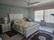 Tranquil bedroom with natural light, tile flooring, and comfortable bed at 333 Lake Howard Nw Dr # 312D, Winter Haven, FL 33880
