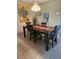 Dining area featuring a wooden table, chairs, and artful decorations at 333 Lake Howard Nw Dr # 312D, Winter Haven, FL 33880