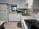 Well-equipped kitchen with white cabinets, modern appliances, and tile backsplash at 333 Lake Howard Nw Dr # 312D, Winter Haven, FL 33880
