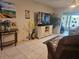 Cozy living space with tile floors, display shelves and entertainment center at 333 Lake Howard Nw Dr # 312D, Winter Haven, FL 33880