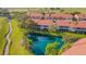 Aerial view of pond and surrounding community with mature trees and lush landscaping at 351 Enclave Dr # 94, Lakeland, FL 33803