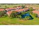 Aerial view of community with multiple ponds, mature trees and lush landscaping at 351 Enclave Dr # 94, Lakeland, FL 33803
