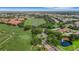 Expansive aerial view showcasing the golf course, community landscaping, and various homes with well-kept lawns at 351 Enclave Dr # 94, Lakeland, FL 33803