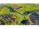 High angle view of golf course, condos, and clubhouse featuring beautiful landscaping and water features at 351 Enclave Dr # 94, Lakeland, FL 33803