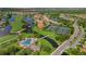 Scenic aerial view of community featuring swimming pool, tennis courts, golf course, and lush landscaping at 351 Enclave Dr # 94, Lakeland, FL 33803