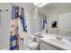 Bright bathroom featuring colorful shower curtain, tub, toilet, sink and vanity at 351 Enclave Dr # 94, Lakeland, FL 33803