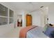 Bright bedroom featuring shuttered windows, a decorative cabinet and a glimpse into an adjacent room at 351 Enclave Dr # 94, Lakeland, FL 33803