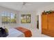 Peaceful bedroom offering scenic views, white carpet and a wicker dresser at 351 Enclave Dr # 94, Lakeland, FL 33803