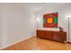 Cozy bedroom featuring a mid-century modern dresser and wood laminate flooring at 351 Enclave Dr # 94, Lakeland, FL 33803