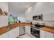 Well-lit kitchen featuring white cabinets, stainless steel appliances, and light countertops at 351 Enclave Dr # 94, Lakeland, FL 33803