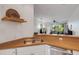 Galley style kitchen with wood countertops and stainless steel appliances looking into living area at 351 Enclave Dr # 94, Lakeland, FL 33803