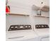 Efficient laundry room with shelving and white washer and dryer at 351 Enclave Dr # 94, Lakeland, FL 33803