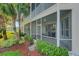 A manicured lawn and landscaping outside the screened in patio of a well maintained home at 351 Enclave Dr # 94, Lakeland, FL 33803