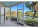 Screened patio with a scenic lake and landscaped waterfall view, perfect for outdoor living at 351 Enclave Dr # 94, Lakeland, FL 33803