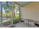 Enjoy the tranquil water view from this screened patio with seating area at 351 Enclave Dr # 94, Lakeland, FL 33803