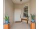 Cozy front porch featuring a wooden bench, potted plants, and a welcome mat at the front door at 351 Enclave Dr # 94, Lakeland, FL 33803