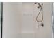 Shower stall with sleek, white tiling, rainfall shower head, and comfortable built-in seating at 351 Enclave Dr # 94, Lakeland, FL 33803