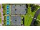 Overhead view of a community tennis complex featuring multiple well-maintained courts surrounded by green spaces at 351 Enclave Dr # 94, Lakeland, FL 33803