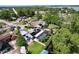 Aerial view of a suburban home featuring a pool, solar panels, and lush landscaping on a spacious lot at 3705 Pine Cir, Lake Wales, FL 33898