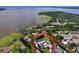 Aerial view showing the house near the lake with a pool and dock surrounded by lush vegetation at 3705 Pine Cir, Lake Wales, FL 33898
