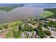 Aerial view of a waterside home featuring mature trees and landscaping, with docks and lake access at 3705 Pine Cir, Lake Wales, FL 33898