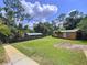 Expansive backyard featuring a lush lawn, outbuilding, and covered area, perfect for outdoor enjoyment and relaxation at 3705 Pine Cir, Lake Wales, FL 33898