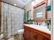 Cozy bathroom featuring a framed mirror, decorative curtain, and a stylish vanity at 3705 Pine Cir, Lake Wales, FL 33898