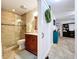 Beautifully renovated bathroom featuring a tiled walk-in shower and a vanity with a granite countertop at 3705 Pine Cir, Lake Wales, FL 33898