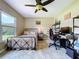 Sunlit bedroom with desk and office setup; patterned bedding and spacious layout at 3705 Pine Cir, Lake Wales, FL 33898
