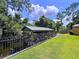 Covered boat dock with metal roof and black iron fence, providing secure water access at 3705 Pine Cir, Lake Wales, FL 33898