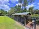 Boat dock with metal roof and black iron fence, offering a secure and private waterfront experience at 3705 Pine Cir, Lake Wales, FL 33898