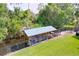 Aerial view of a covered boat dock featuring a metal roof and black iron fence at 3705 Pine Cir, Lake Wales, FL 33898