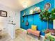 Charming entryway with vibrant blue decor and a cozy bench at 3705 Pine Cir, Lake Wales, FL 33898