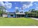 Charming single-Gathering home featuring a covered carport, solar panels, and a well-manicured lawn at 3705 Pine Cir, Lake Wales, FL 33898