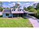 Charming single-Gathering home featuring a covered carport, solar panels, and a well-manicured lawn at 3705 Pine Cir, Lake Wales, FL 33898