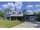 Charming single-Gathering home featuring a covered carport, solar panels, and a well-manicured lawn at 3705 Pine Cir, Lake Wales, FL 33898
