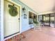 Charming front door entrance featuring a decorative wreath and a 'Welcome to Our Home' sign at 3705 Pine Cir, Lake Wales, FL 33898