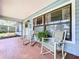 Inviting front porch featuring rocking chairs, brick flooring, and a welcoming atmosphere at 3705 Pine Cir, Lake Wales, FL 33898